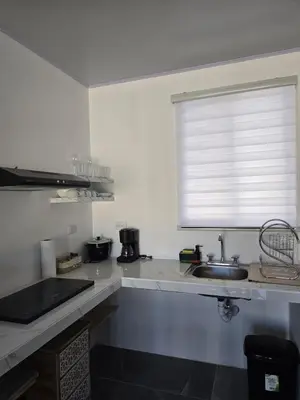 a kitchen with a sink and a window at Casa Motmot en Liberia in Liberia