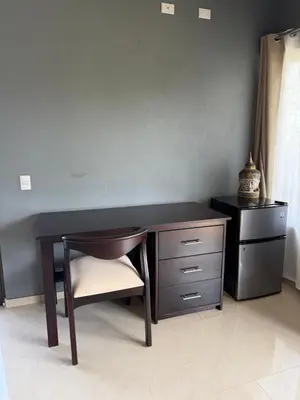 a wooden desk with a chair and a dresser at Hacienda Santa Elena in Santa Cruz