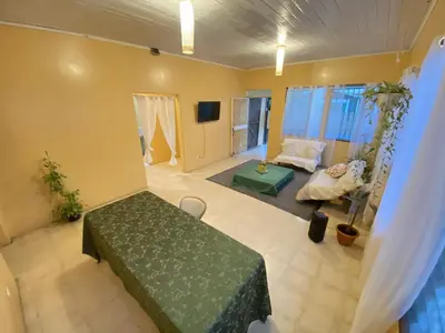 a living room with a bed and a couch at Casa Todah Av 5 in Liberia