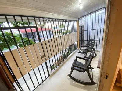 two chairs sitting on the balcony of a building at Casa Todah Av 5 in Liberia