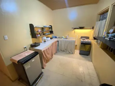a kitchen with a table in the middle of a room at Casa Todah Av 5 in Liberia