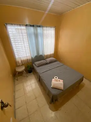a bedroom with a bed with a towel on it at Casa Todah Av 5 in Liberia