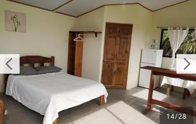 a bedroom with a bed and a table and a desk at Cielo Azul in Monteverde Costa Rica