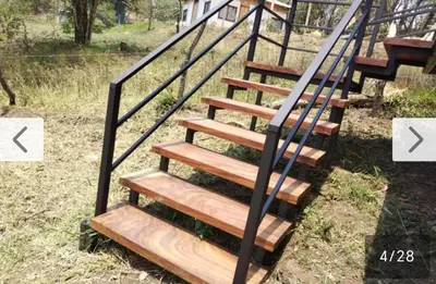 a set of wooden stairs with a metal railing at Cielo Azul in Monteverde Costa Rica