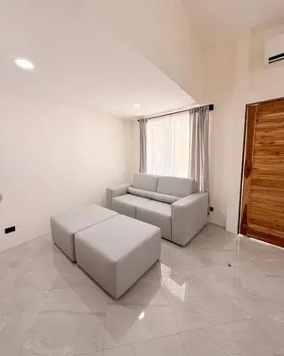 a living room with a couch and a table at Brianne's Place in Playa hermosa