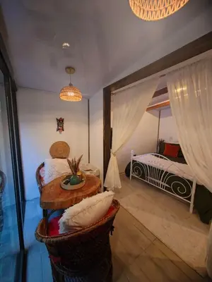 a bedroom with a bed and a table in a room at Cozy Café Studio in El Copey