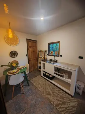 a kitchen with a table and a sink and a table at Cozy Café Studio in El Copey