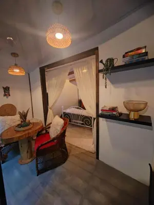 a bedroom with a bed and a table and a mirror at Cozy Café Studio in El Copey