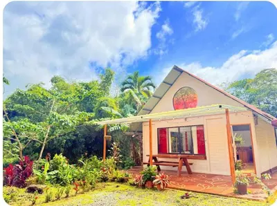 a small house with a bench in front of it at Mystic Solarium Private Indoor Pool in Chachagua