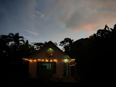 a small house with christmas lights on top of it at Mystic Solarium Private Indoor Pool in Chachagua