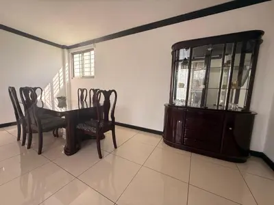 a dining room with a table and chairs and a cabinet at DescansoAIRBNB in La Asunción