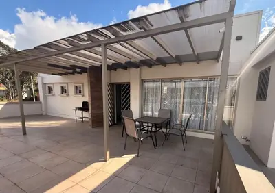 a pergola on a patio with a table and chairs at DescansoAIRBNB in La Asunción