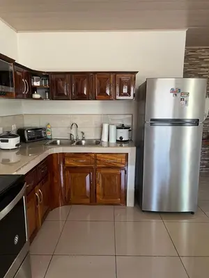 a kitchen with a stainless steel refrigerator and wooden cabinets at Vacation Home in Santa Cruz in Santa Cruz