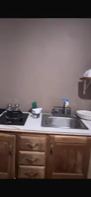 a kitchen with a sink and a stove at Quinta Don Ebal in Guácimo