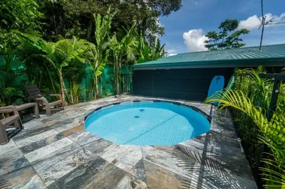 a swimming pool on a patio with a building at Inta Tiny House in Fortuna