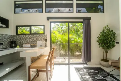 a kitchen with a table and chairs and a window at Inta Tiny House in Fortuna