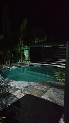 a small swimming pool at night with a fence at Inta Tiny House in Fortuna