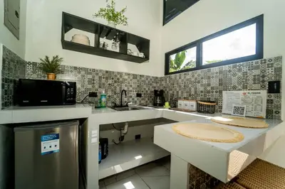 a kitchen with a sink and a microwave at Inta Tiny House in Fortuna