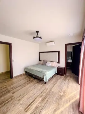 a bedroom with a bed and a wooden floor at Casa Pura Vida in Coco
