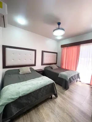 a room with two beds and a window at Casa Pura Vida in Coco