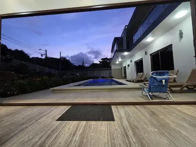 a patio with a chair and a swimming pool at Casa Pura Vida in Coco