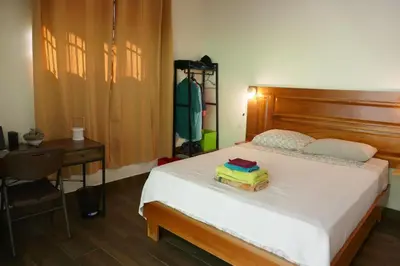 a bedroom with a bed with a table and a chair at Casa de la Diversidad - La Casita - Ojochal in Ojochal