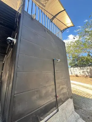 a metal garage door with a water hose on it at Villa Sonia in Caldera