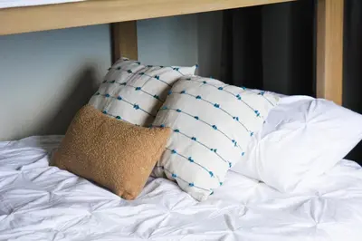 a bed with two pillows on top of it at Cabina Alto San Juan l Mountain Luxury Getaway in San Juan
