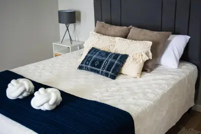 a bedroom with a bed with pillows on it at Cabina Alto San Juan l Mountain Luxury Getaway in San Juan