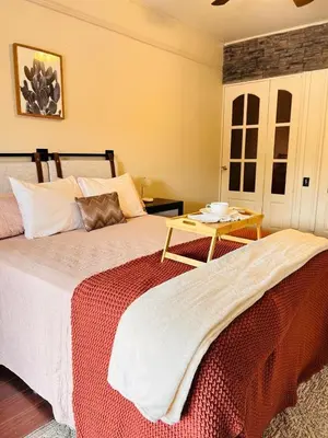 a bedroom with two beds and a coffee table at Apolo Loft in Guápiles