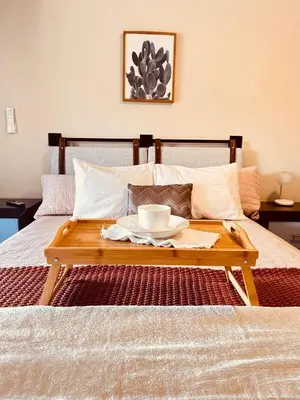 a tray with a bowl on top of a bed at Apolo Loft in Guápiles