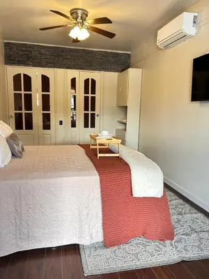 a bedroom with a large bed with a ceiling fan at Apolo Loft in Guápiles