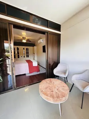 a bedroom with a bed and a table and chairs at Apolo Loft in Guápiles