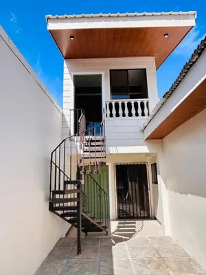 a staircase leading up to a house with a balcony at Apolo Loft in Guápiles