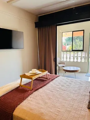 a bedroom with a large bed with a table on it at Apolo Loft in Guápiles