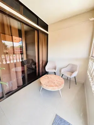 a living room with a table and two chairs at Apolo Loft in Guápiles
