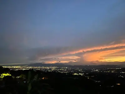 a view of a city with a rainbow in the sky at Magic Lodge - Cirrí, Naranjo