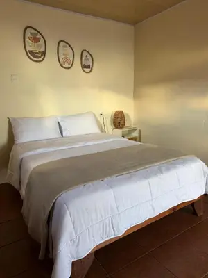 a bedroom with a large bed with three plates on the wall at Magic Lodge - Cirrí, Naranjo