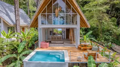 a house with a pool in the middle of a forest at Casa Terra - Modern House with Ocean Views in Santa Teresa Beach