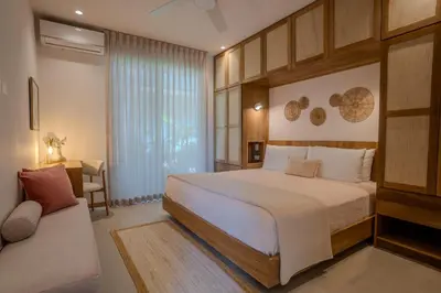 a bedroom with a large bed and a couch at Casa Terra - Modern House with Ocean Views in Santa Teresa Beach