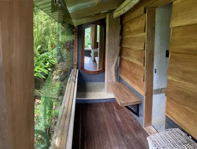 an internal view of a tiny house with a large window at Finca Lilly in Upala