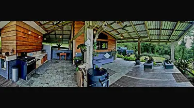 an outdoor patio with a kitchen and a stove at Finca Lilly in Upala