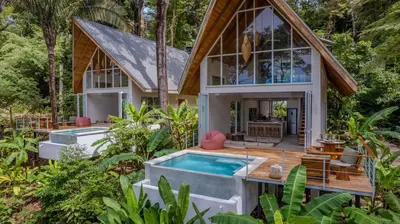 an exterior view of a house with a swimming pool at Casa Solana - Modern House with Ocean Views in Santa Teresa Beach