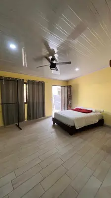 a bedroom with a bed and a ceiling fan at Casita Pacifica in Playa Grande