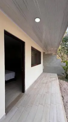 an empty room with a bed and a wooden floor at Casita Pacifica in Playa Grande