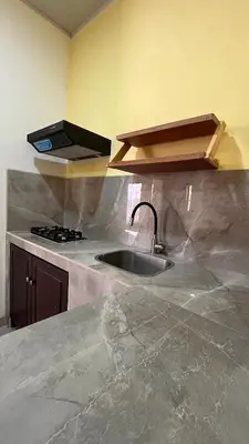 a kitchen with a sink and a stove at Casita Pacifica in Playa Grande