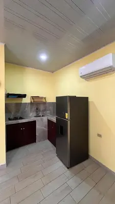 a kitchen with a black refrigerator in a room at Casita Pacifica in Playa Grande