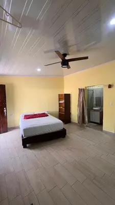 a bedroom with a bed and a ceiling fan at Casita Pacifica in Playa Grande