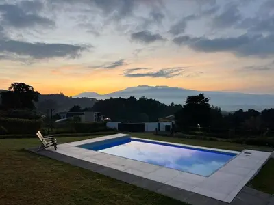a swimming pool in a yard with a bench next to it at AO Buena Vista Home - Panoramic View in Concepción