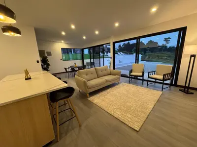 a living room with a couch and a table and chairs at AO Buena Vista Home - Panoramic View in Concepción